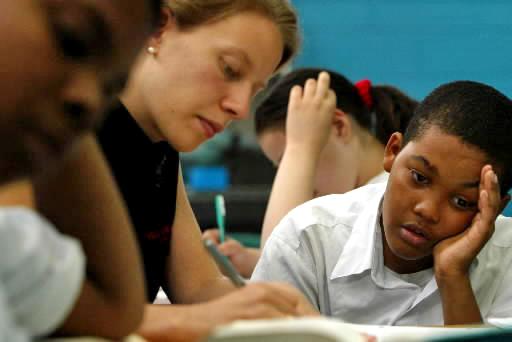 A teacher works with one of her students