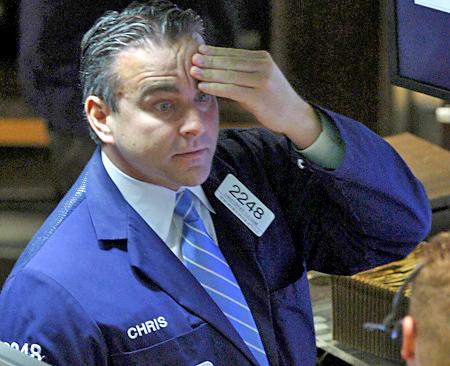 A trader at the New York Stock Exchange watches as the markets plunge