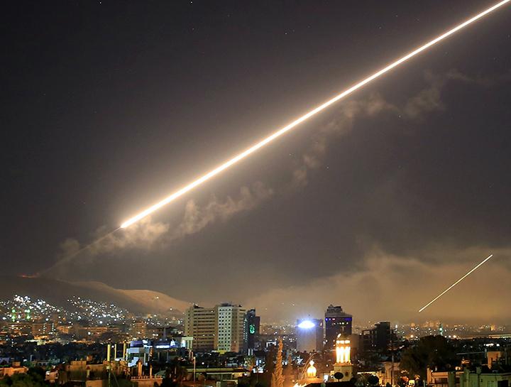 U.S. missiles streak across the sky over Damascus