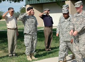 Supporters salute as war resister Travis Bishop (far right) is led away