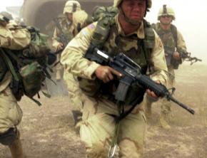 U.S. soldiers rush off a Chinook helicopter in Afghanistan