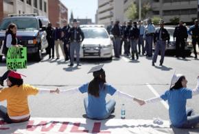 Immigrant rights activists stop traffic at a busy Atlanta intersection