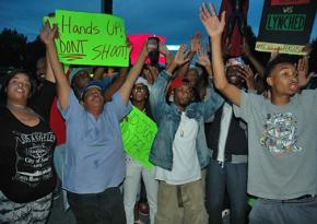 Residents gather in Ferguson, Mo., for an evening protest against police violence