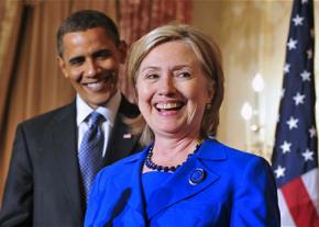 Hillary Clinton speaks as Barack Obama looks on