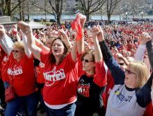 Teachers stand together in solidarity in outside the state Capitol in Charleston