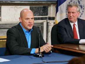 UFT President Michael Mulgrew speaks as Mayor Bill de Blasio looks on